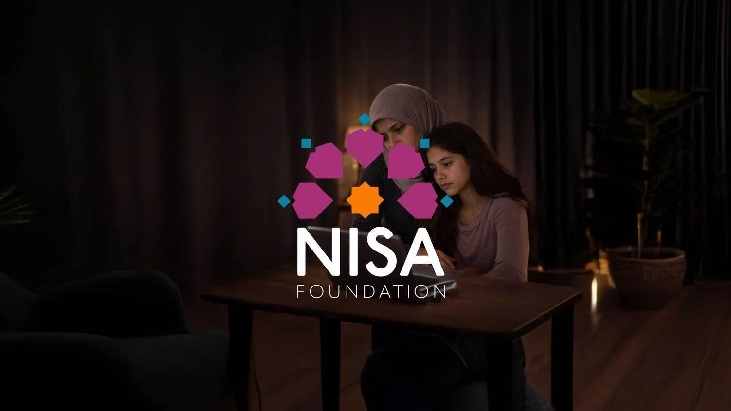 A woman and a girl sitting at a table viewing a phone or a tablet, with the NISA Foundation logo overlaid on the image.