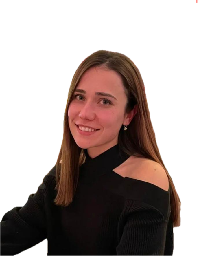 A woman with light brown hair, wearing a black off-the-shoulder sweater, smiling at the camera.