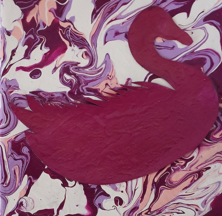 A red paper cut-out of a flamingo placed on a purple and cream swirled marbled background.