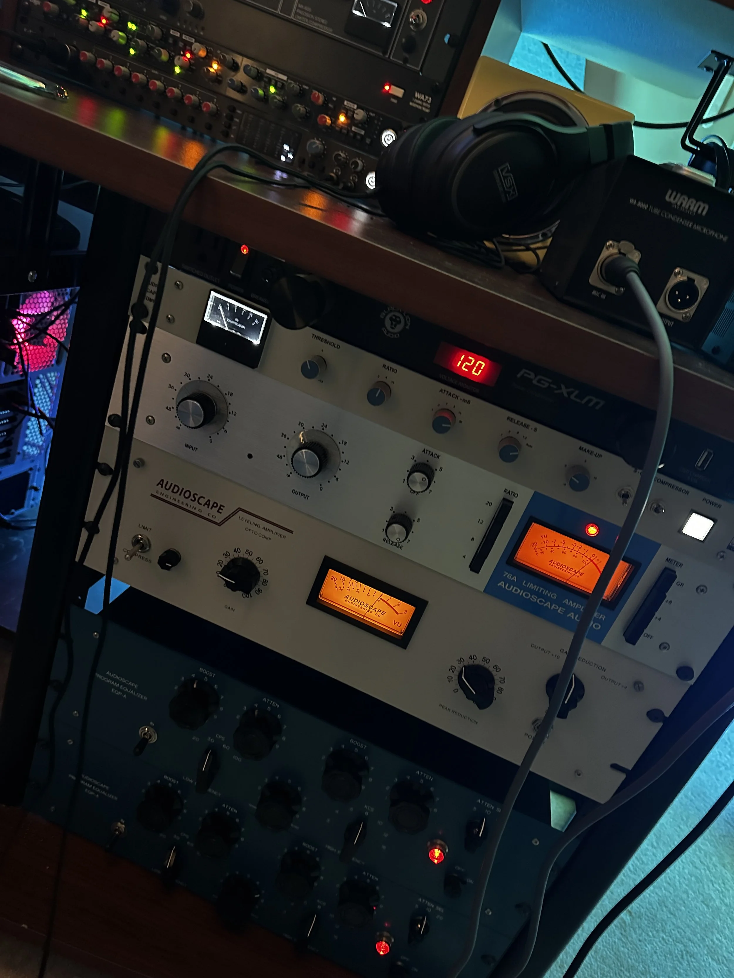 Audio equipment including a rack-mounted audio compressor and an audio limiter, microphones, headphones, and various audio control devices.