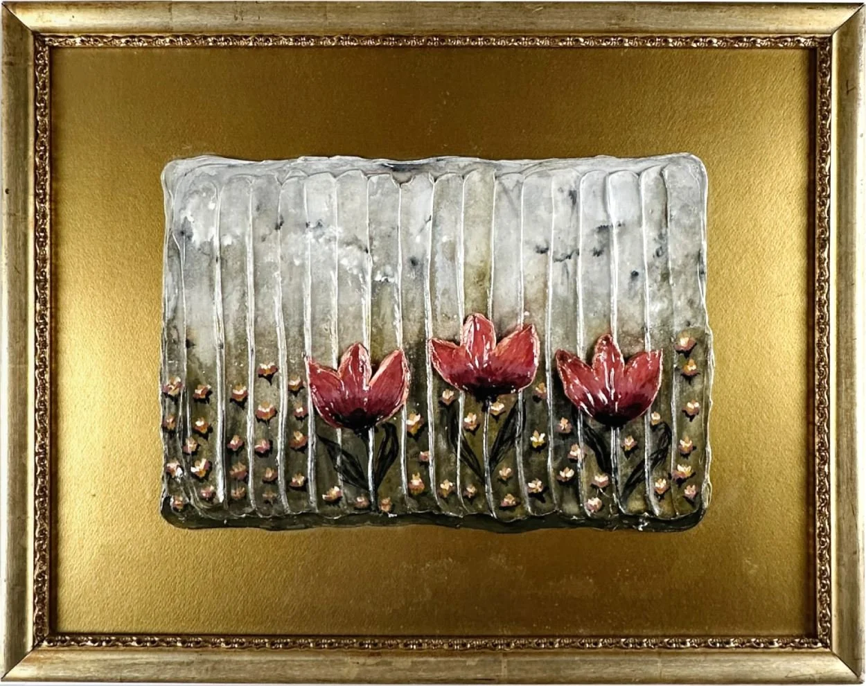 Framed artwork featuring three painted red flowers with green stems on a textured silver background with small black accents.