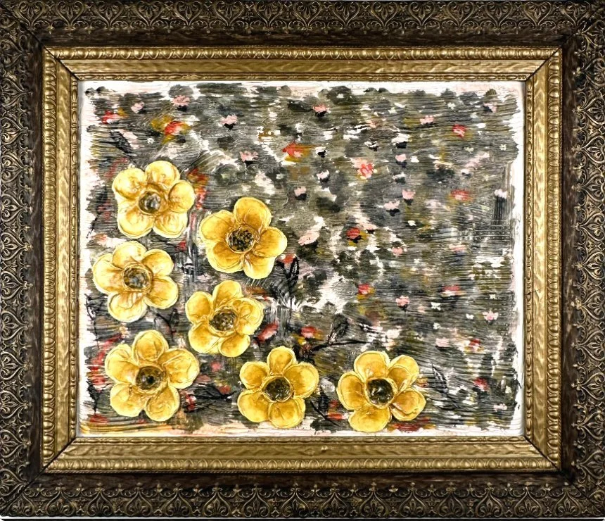 Painted artwork of yellow flowers with dark centers on a textured background framed in ornate gold and black frame.