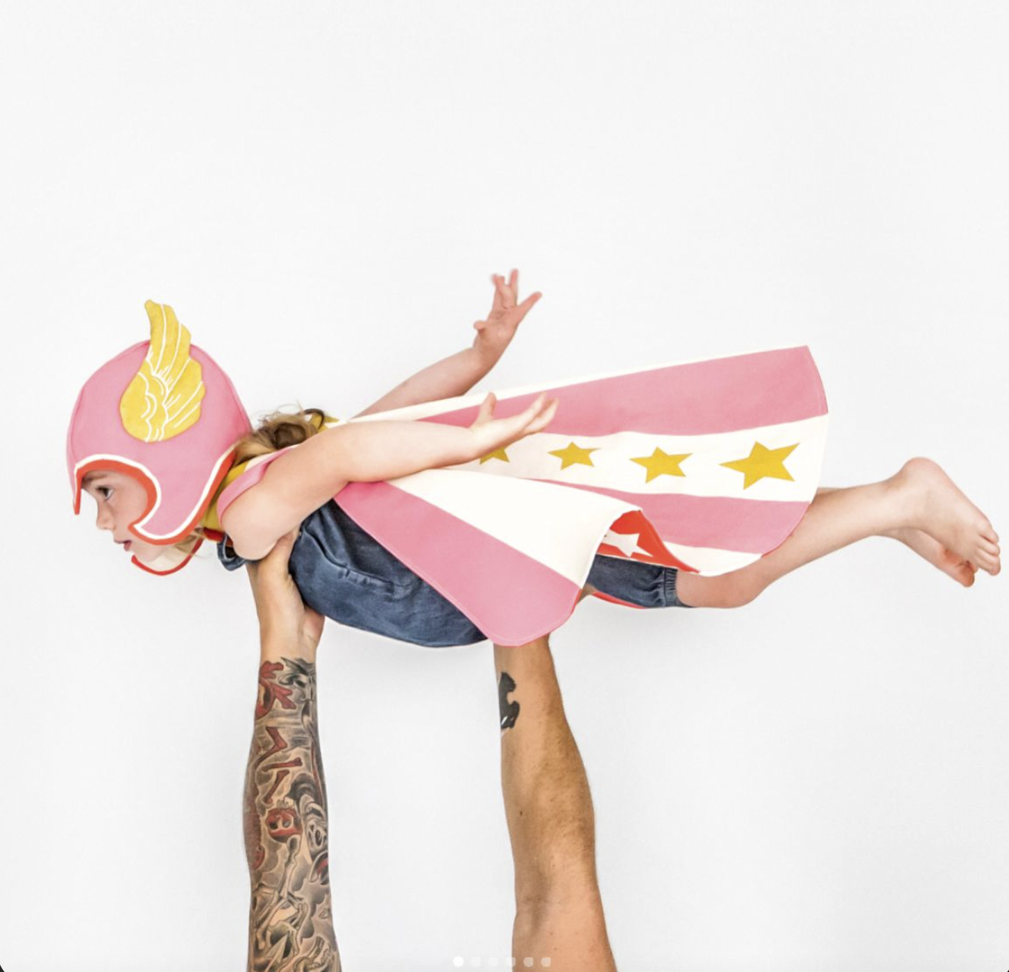Child enjoying imaginative superhero play activity at The Kids Club
