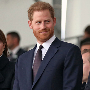 Man with red hair and beard in a dark suit at a formal event