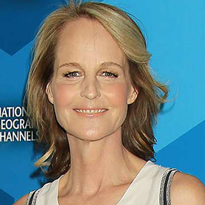 A woman smiling with shoulder-length blonde hair against a blue background.