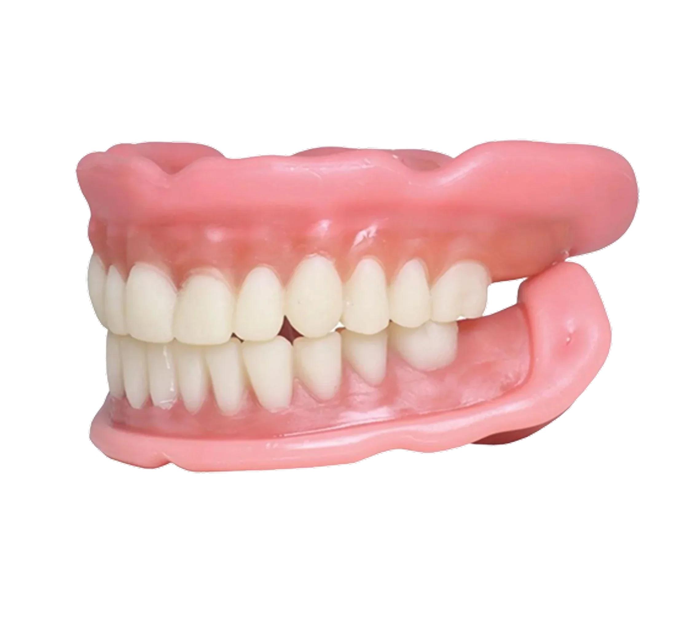 A classic set of dentures with upper and lower teeth and gums, isolated on a black background.
