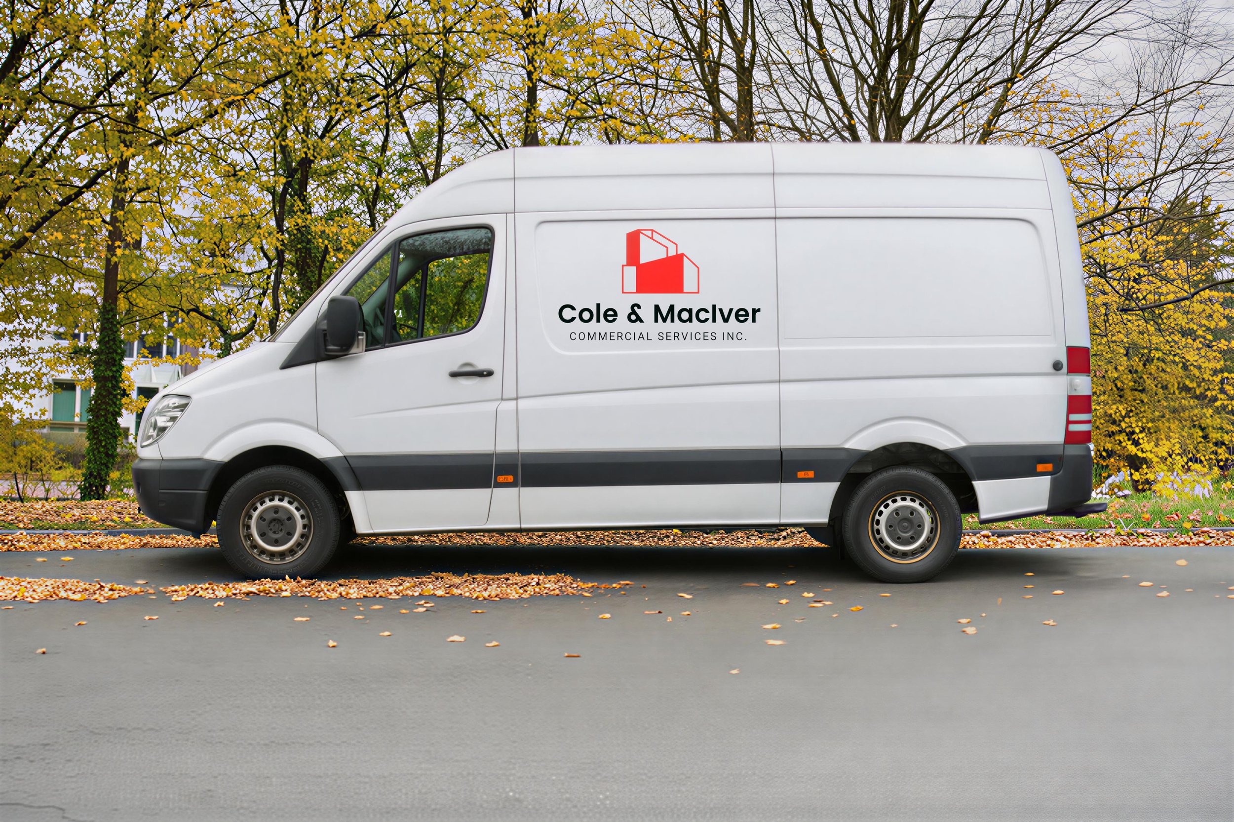 White commercial delivery van with Cole & MacIver logo parked on a tree-lined street in autumn.
