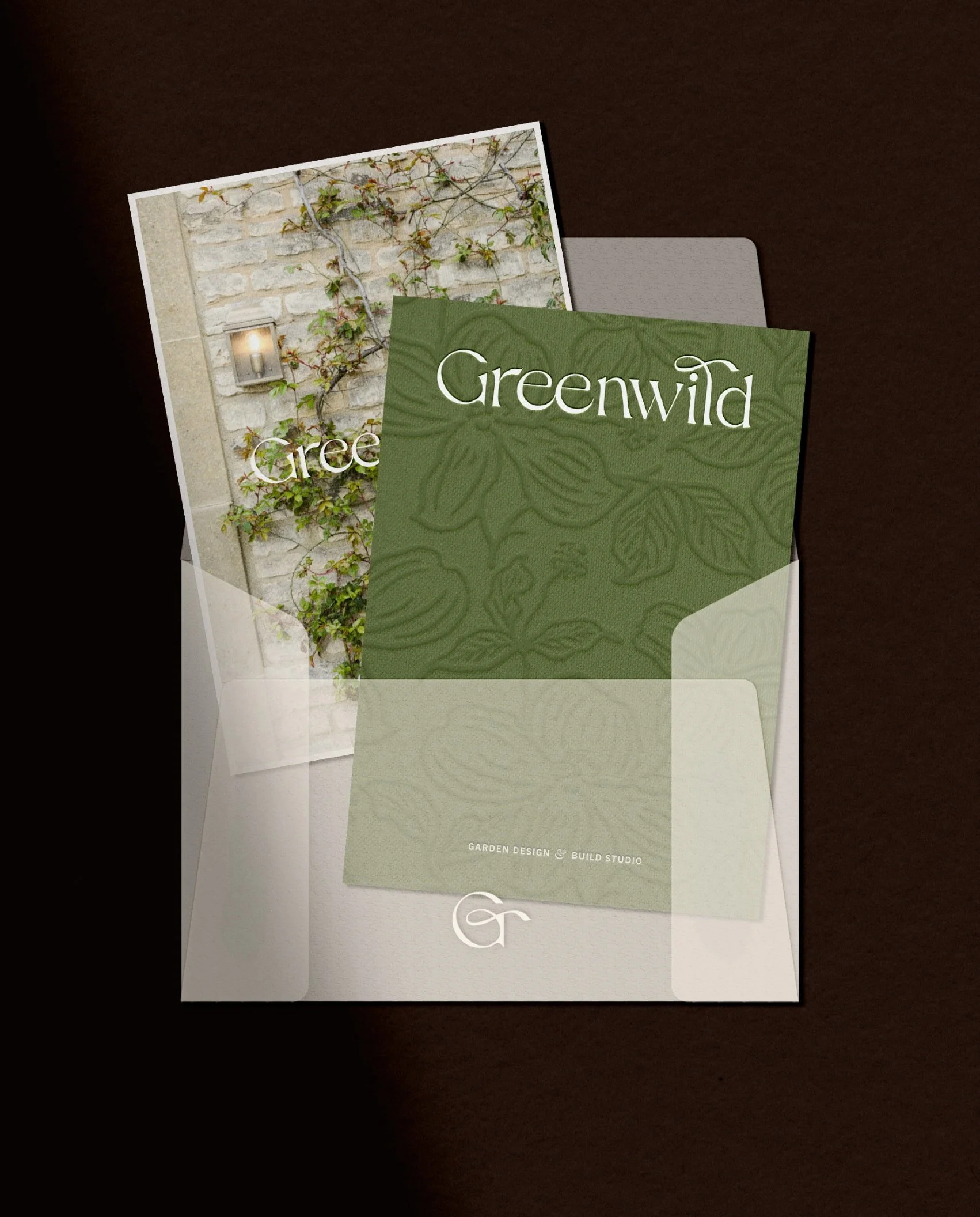 Translucent vellum envelope holding a Greenwild floral brand card and a high-resolution photograph of a lush garden