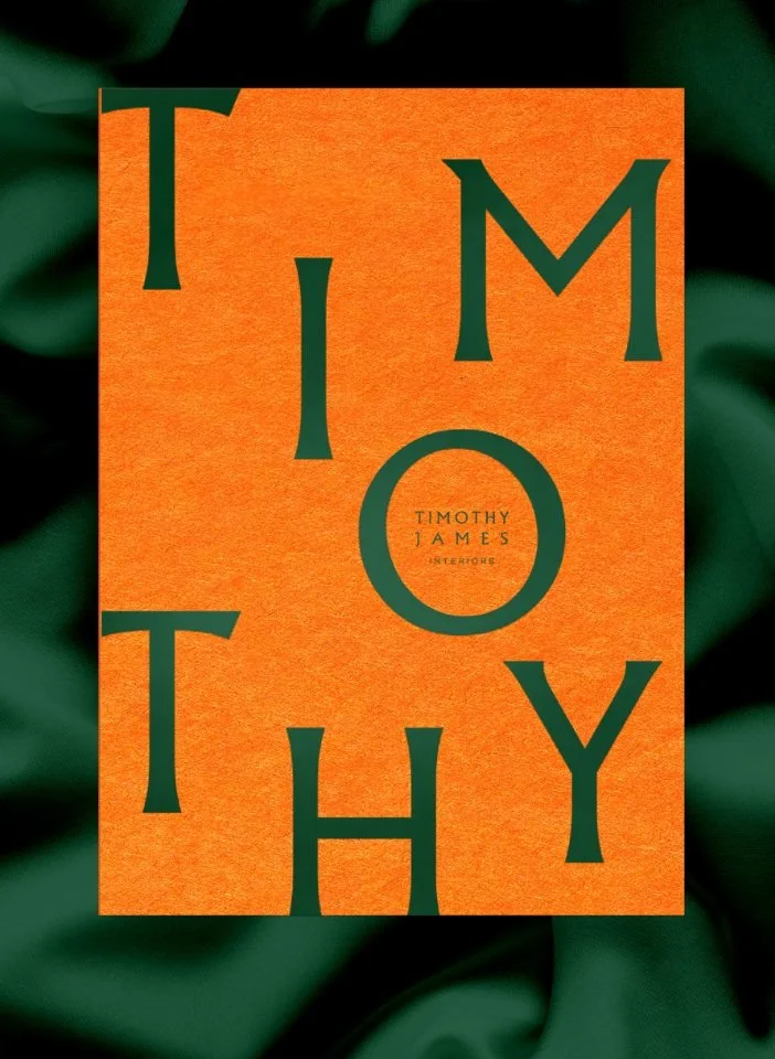 A textured orange card with large dark green serif typography spelling Timothy set against a draped silk background