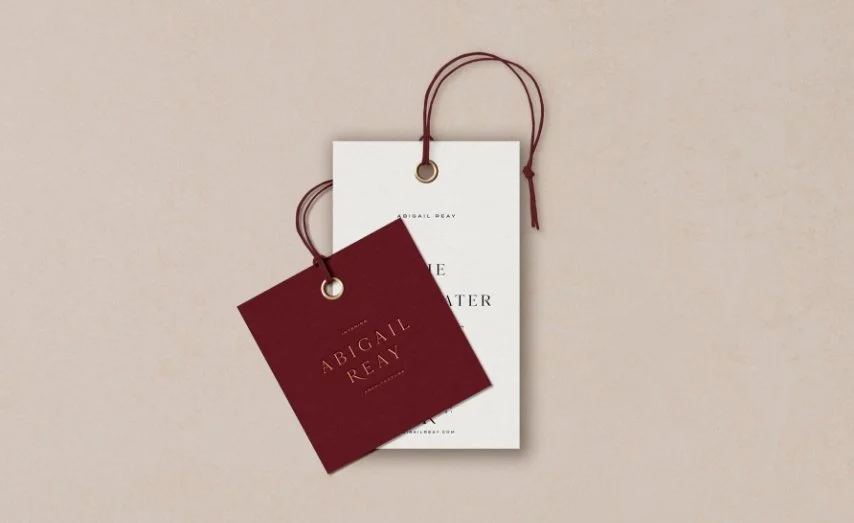 Neutral toned sofa with textured cushions and bespoke modern abstract textile art for an Abigail Reay London home project