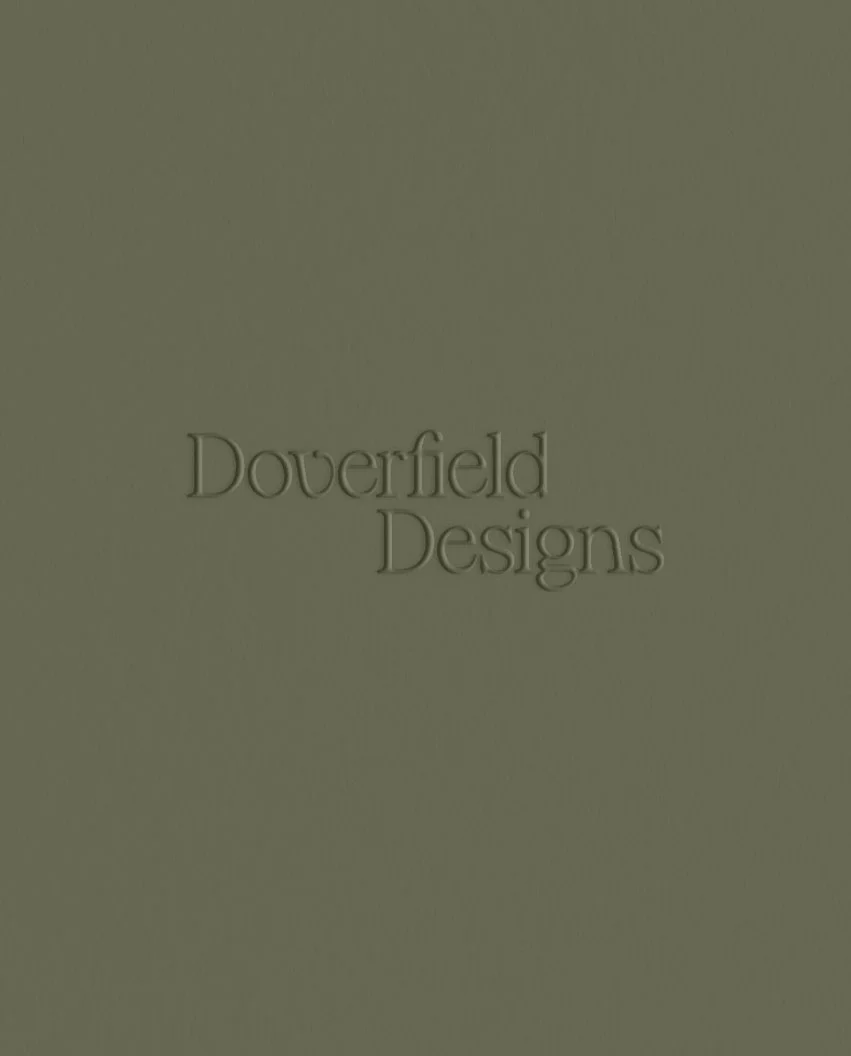 Close up of the brand name debossed into a textured sage green surface creating a subtle and sophisticated 3D effect