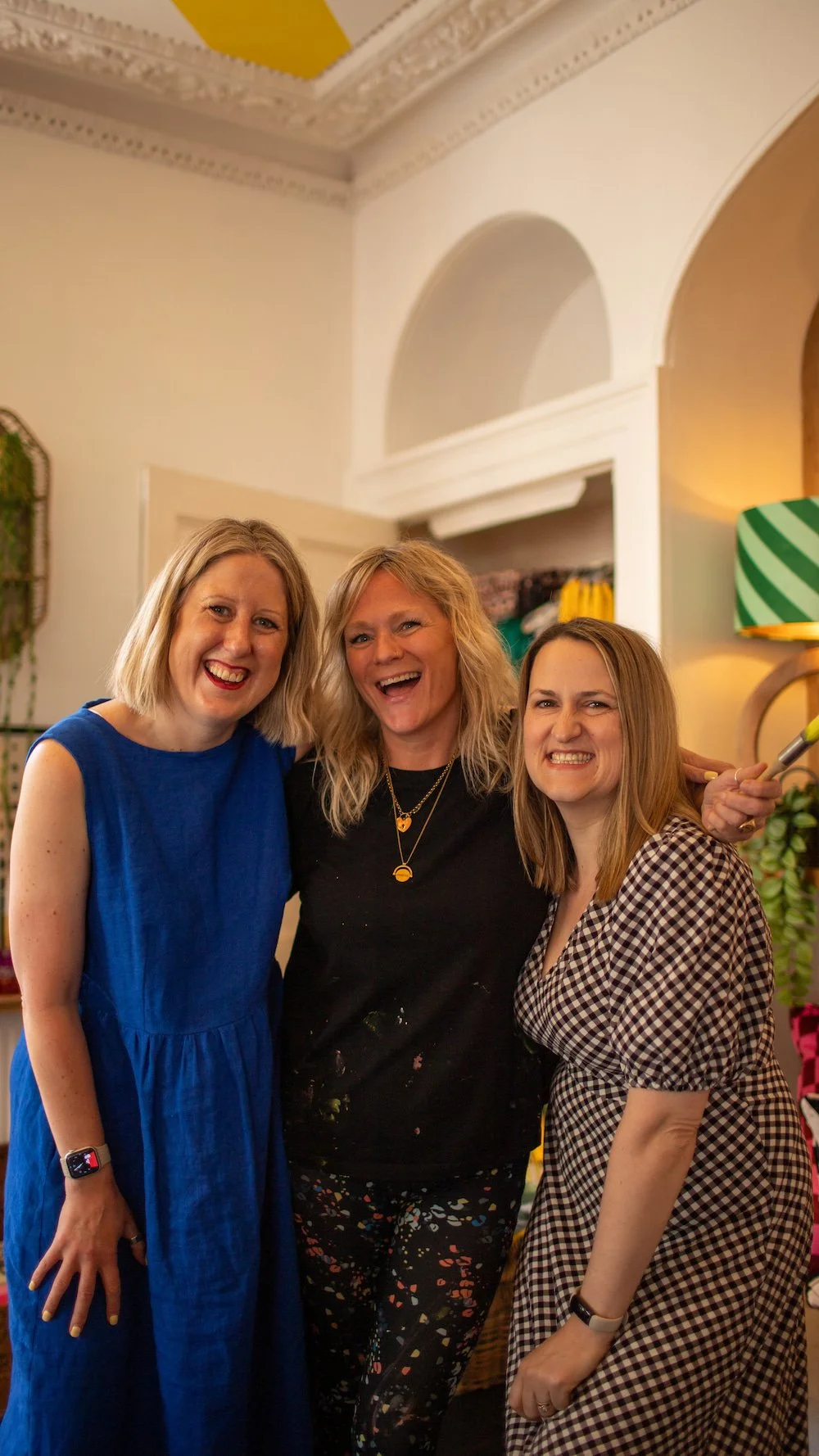 Three women smiling and embracing during a business social event at the Love Frankie boutique in Totnes Devon England