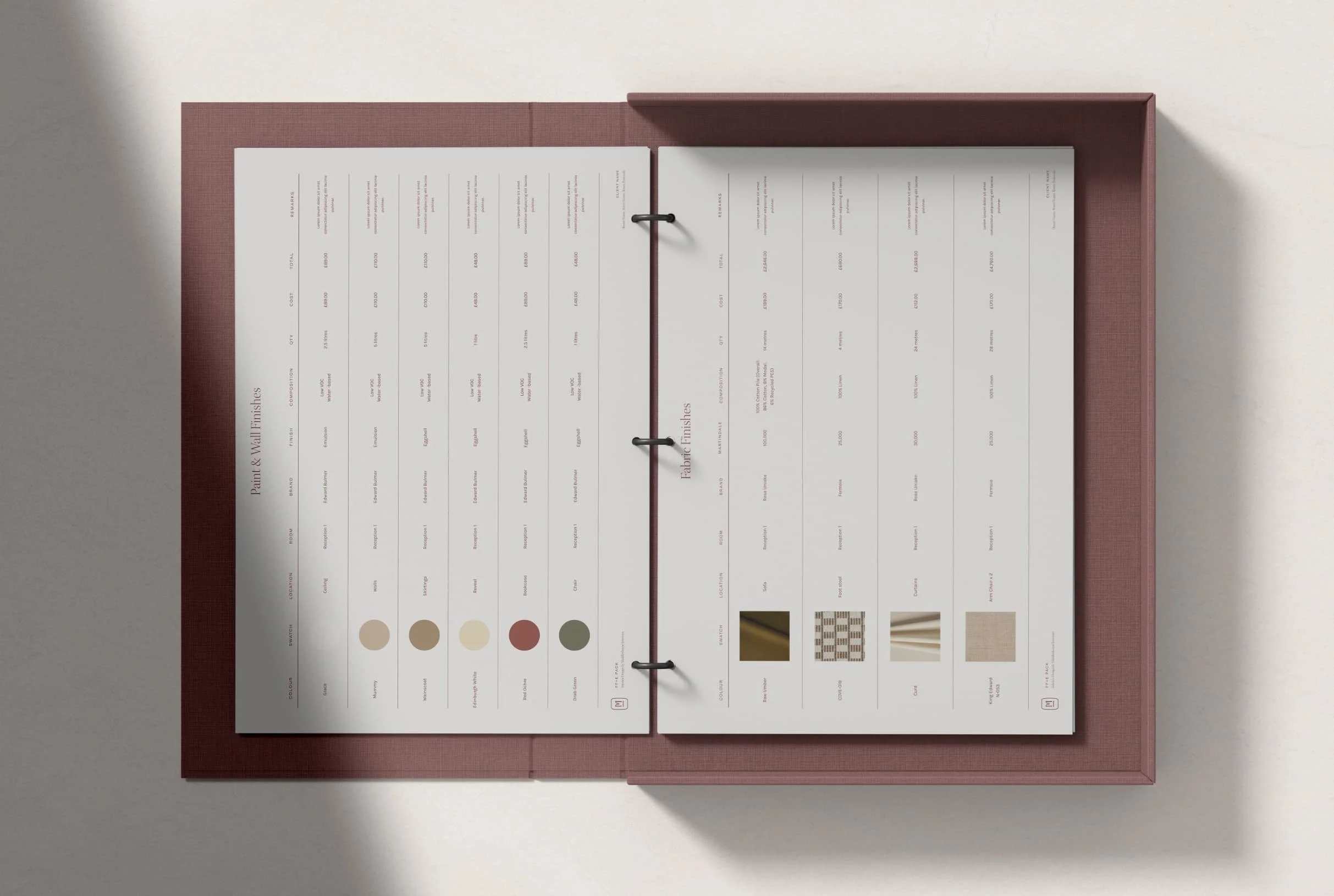 Open specification binder showing paint and wall finish charts with colour swatches and fabric finish samples for a project