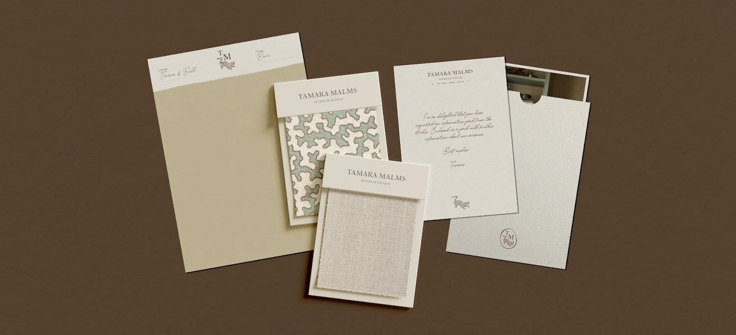 Interior design brand stationery featuring a neutral paint sample, patterned fabric swatches and a handwritten note