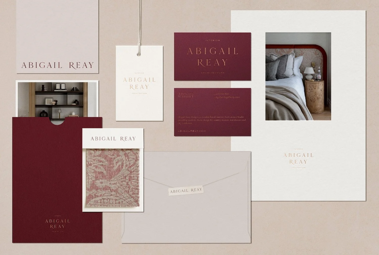 Collection of Abigail Reay branded stationery including business cards and fabric swatches in a sophisticated colour palette