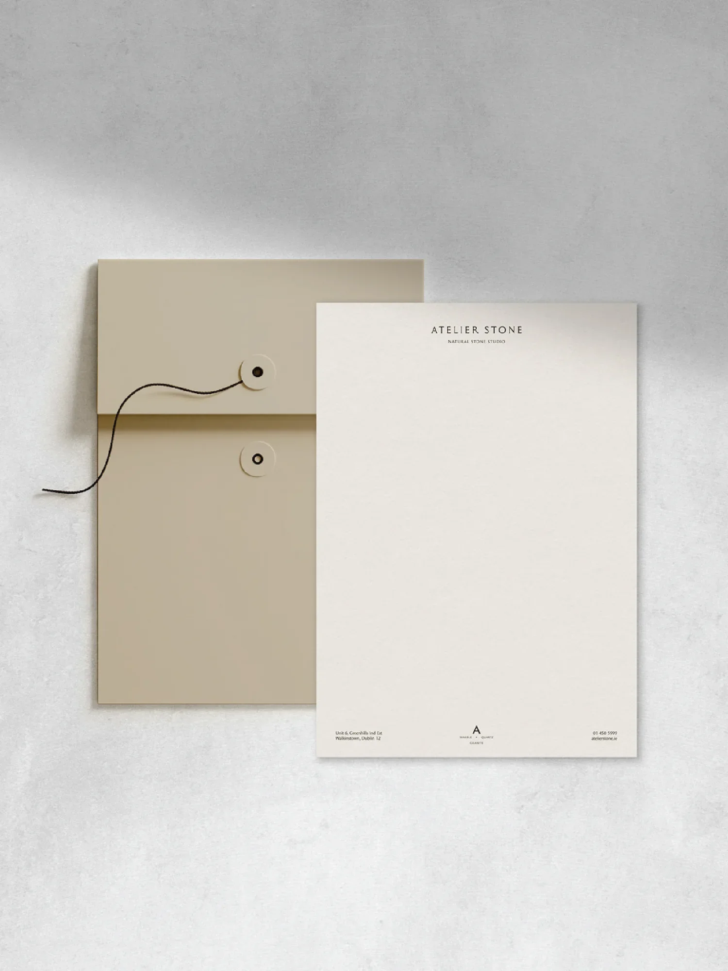 Minimalist stationery for Atelier Stone natural stone studio featuring a tan string tie envelope and clean white letterhead