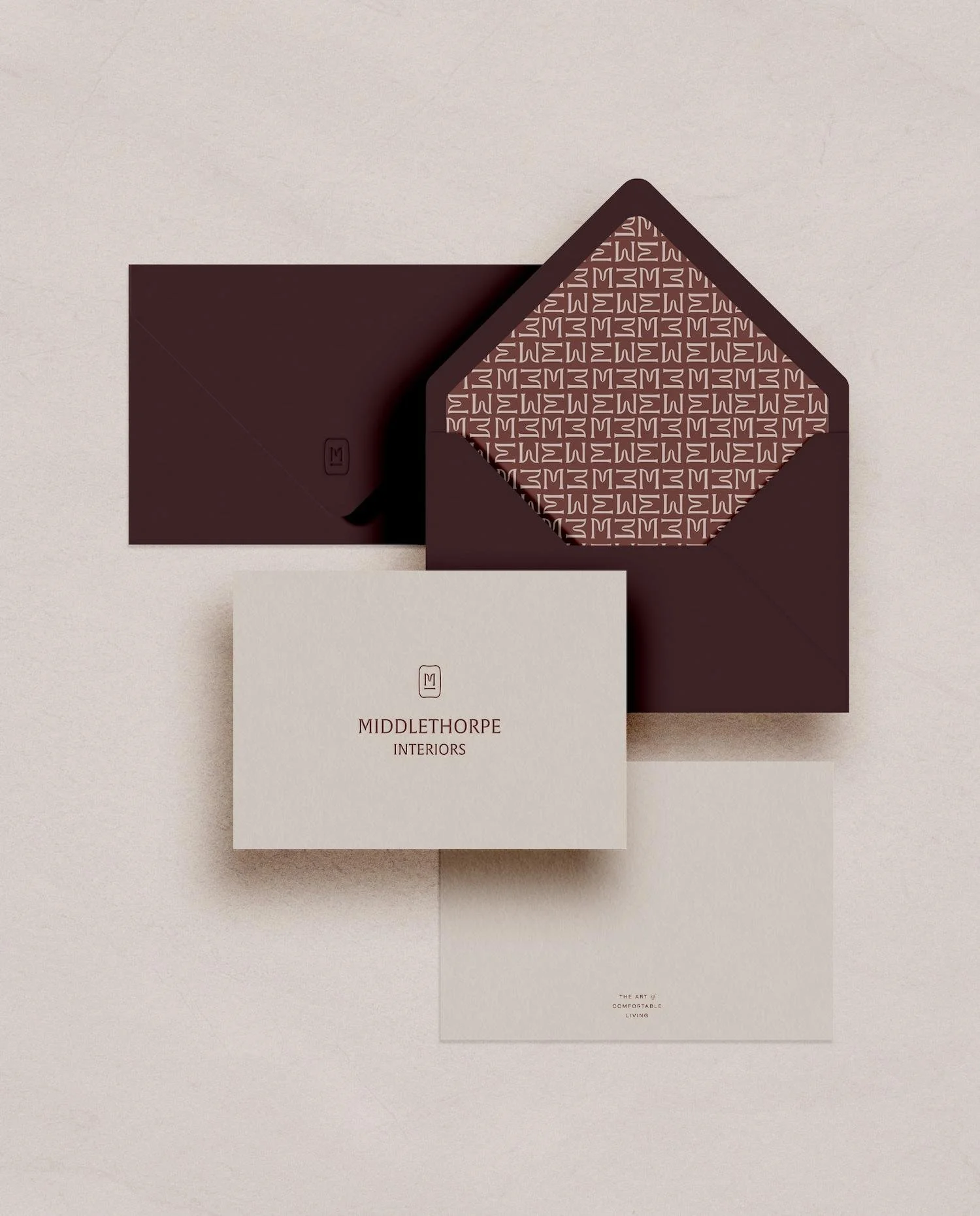 Professional stationery set with Middlethorpe Interiors logo on business cards and patterned envelope liners in burgundy