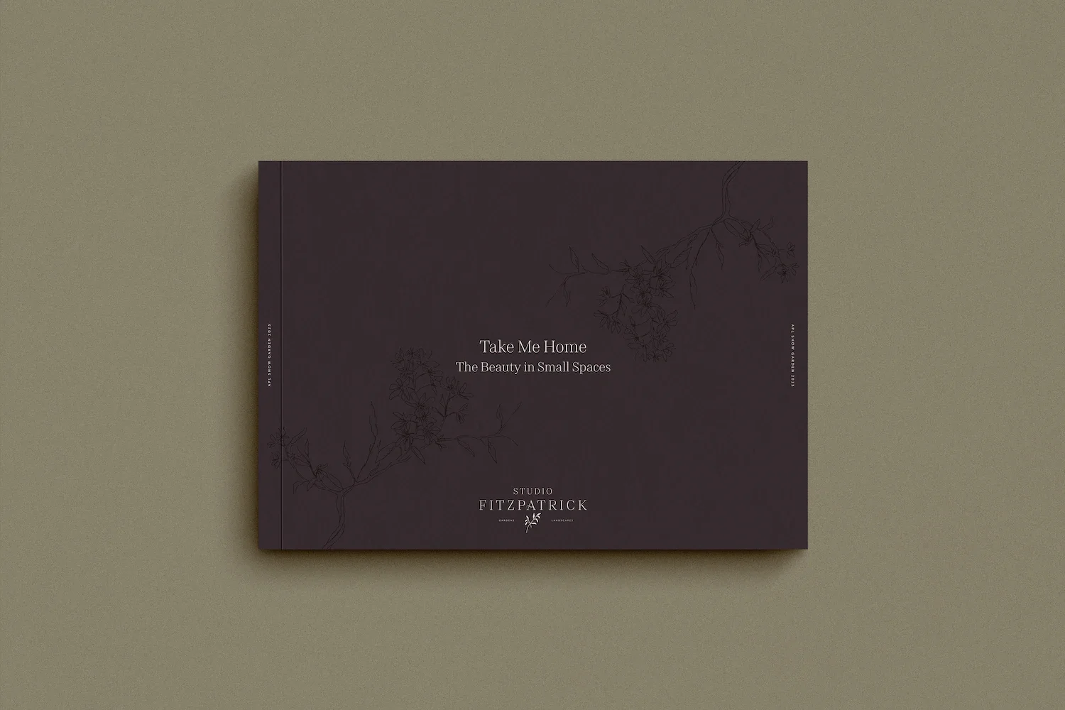 Elegant dark brown brochure cover titled Take Me Home featuring delicate botanical branch line drawings and a serif logo