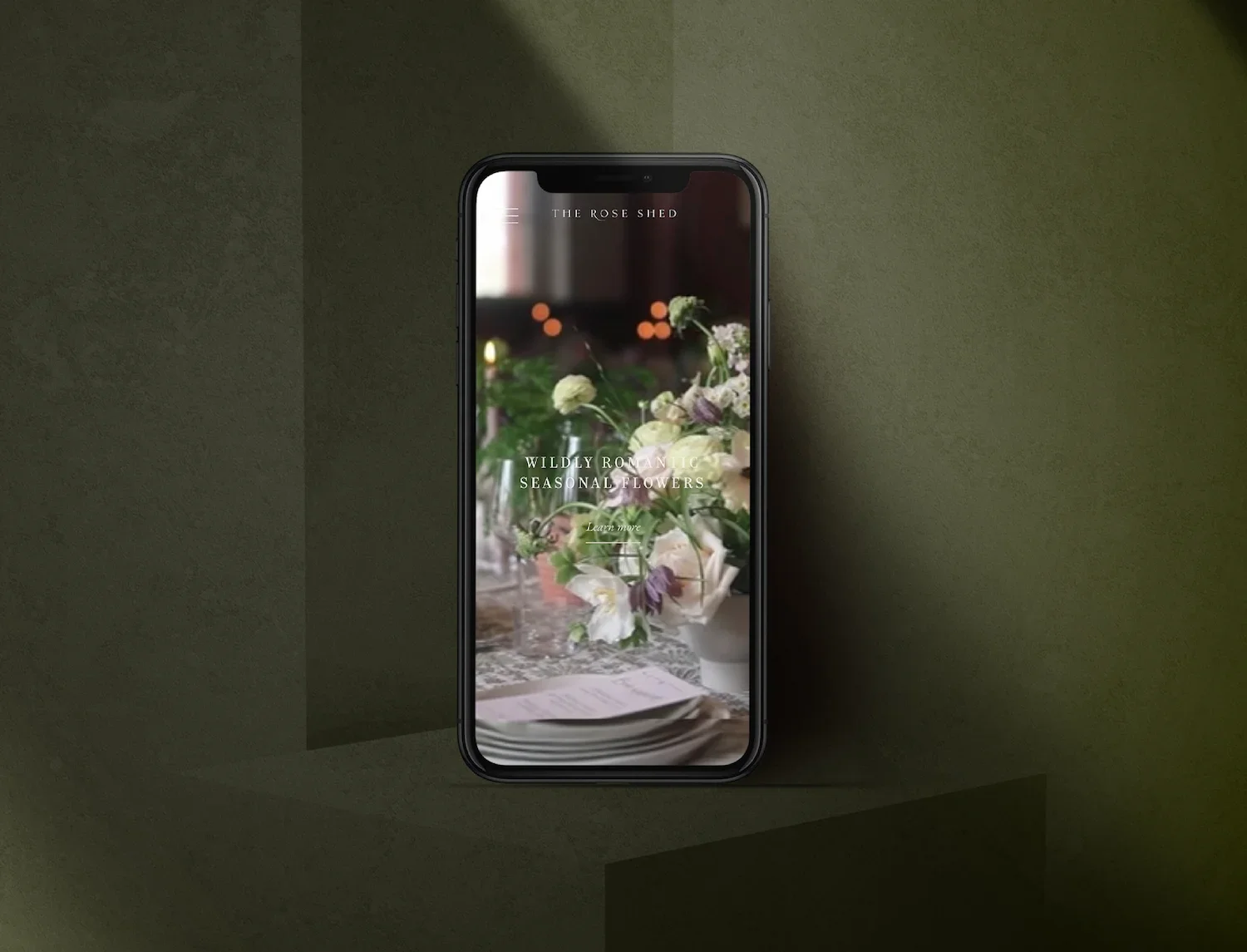 Bespoke mobile website design for Devon wedding florist The Rose Shed displaying elegant seasonal flowers on an iPhone mockup