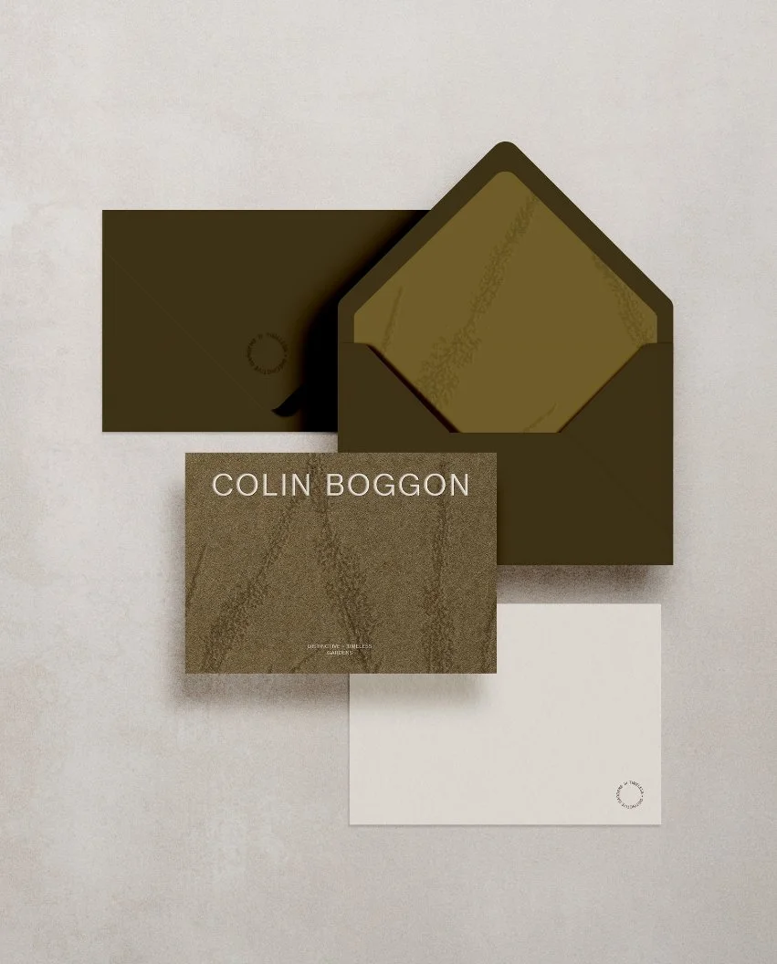 High-quality stationery for a garden designer featuring olive green envelopes and a textured card with embossed botanicals