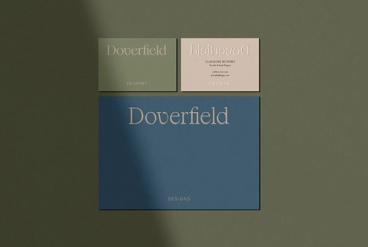 Professional stationery set with green and beige business cards and a large blue card featuring the studio logo