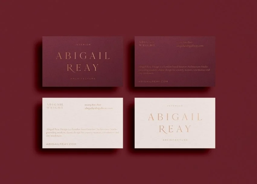 Abigail Reay business cards in deep burgundy and cream featuring elegant gold foil typography for the London design studio