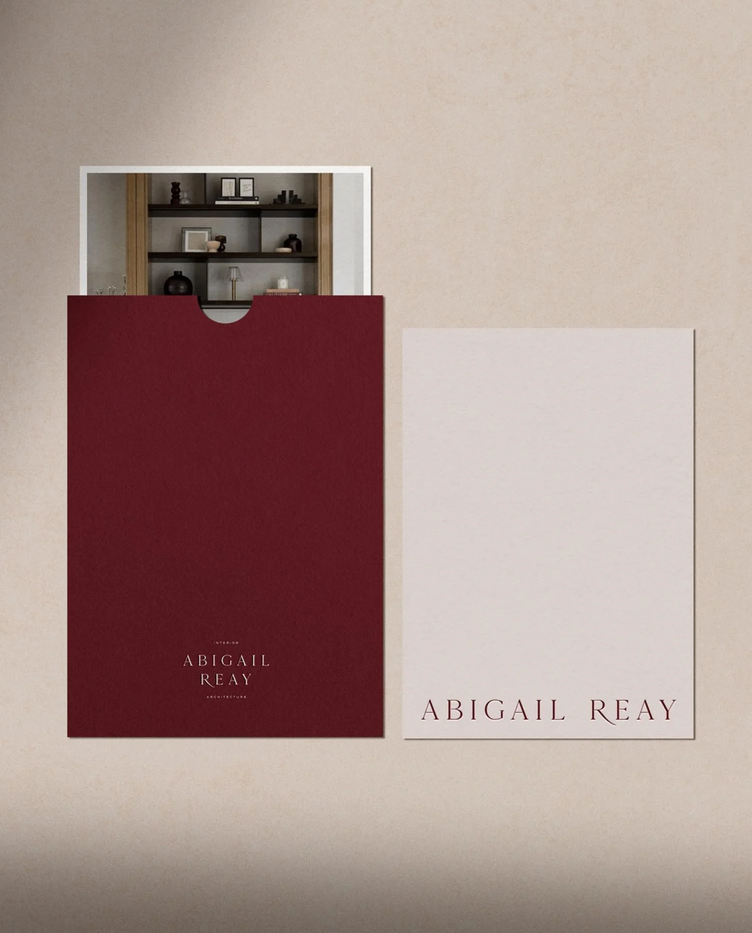 Abigail Reay branded letterhead with a signature from Abigail Wright placed next to a luxury burgundy string tie envelope