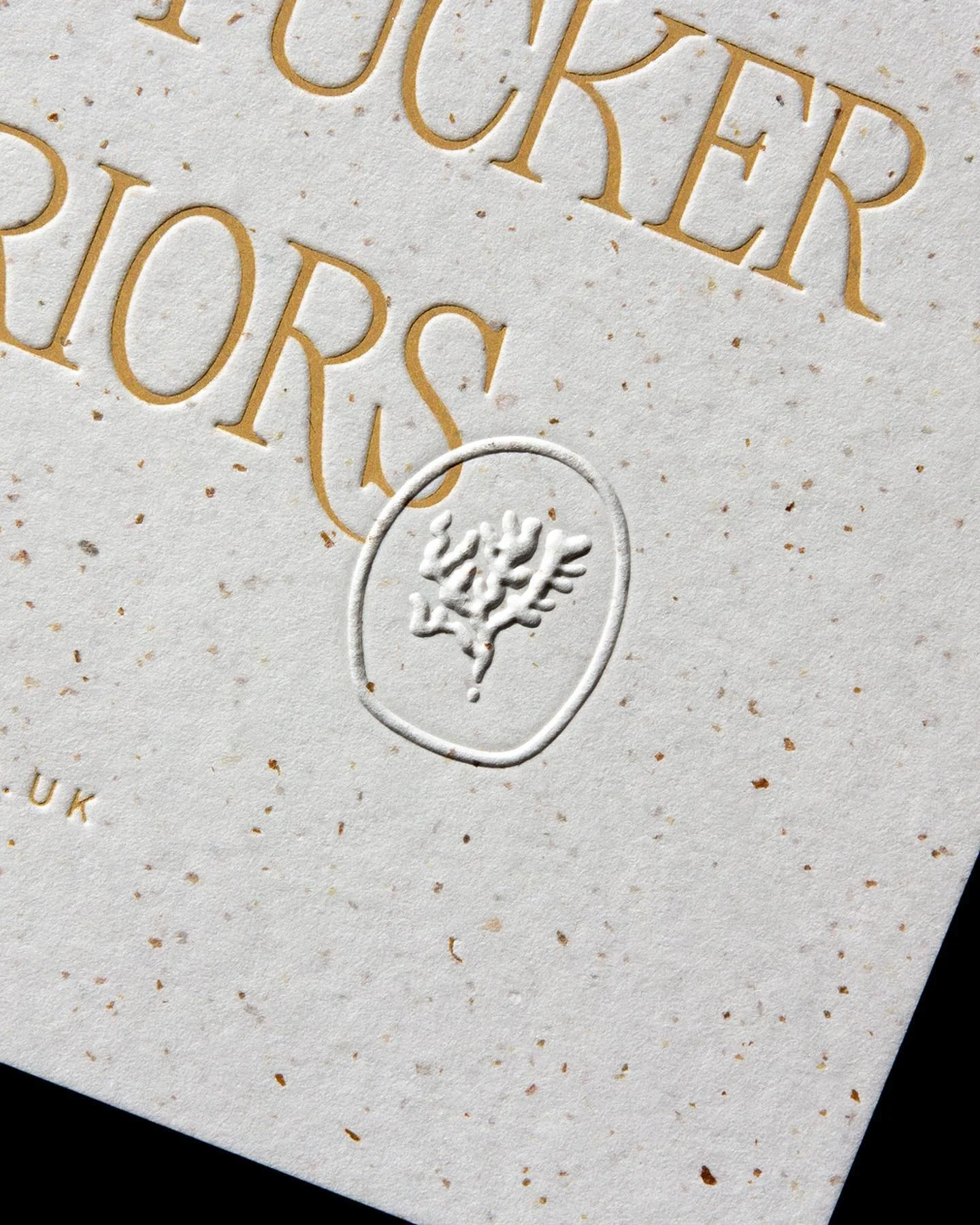 Interior designer's business card with gold foil blocking, embossed seaweed icon printed on fleckled off-white cardstock