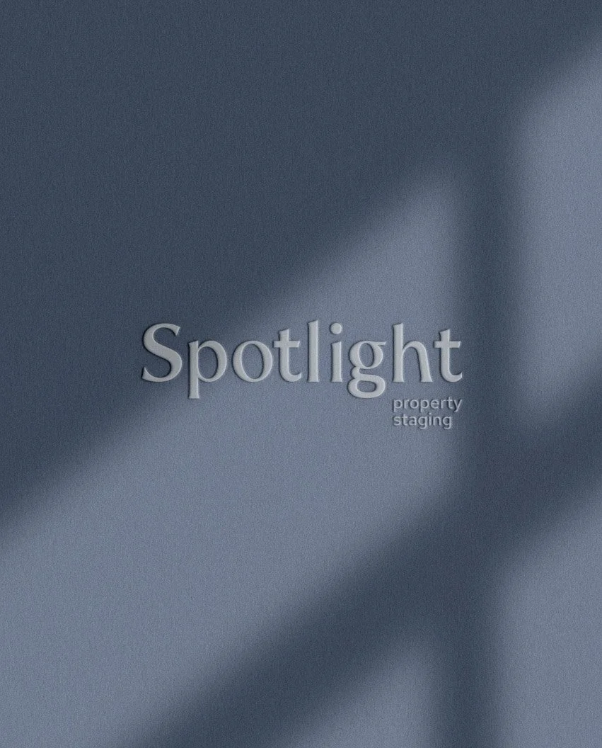Spotlight property staging wordmark logo in a clean serif font with a soft shadow effect on a blue textured paper background