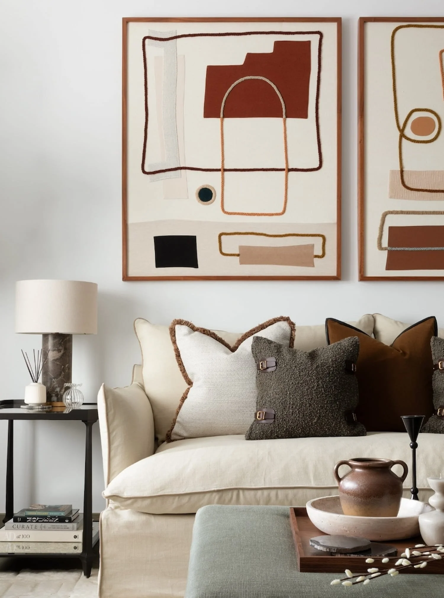 Neutral toned sofa with textured cushions and bespoke modern abstract textile art for an Abigail Reay London home project