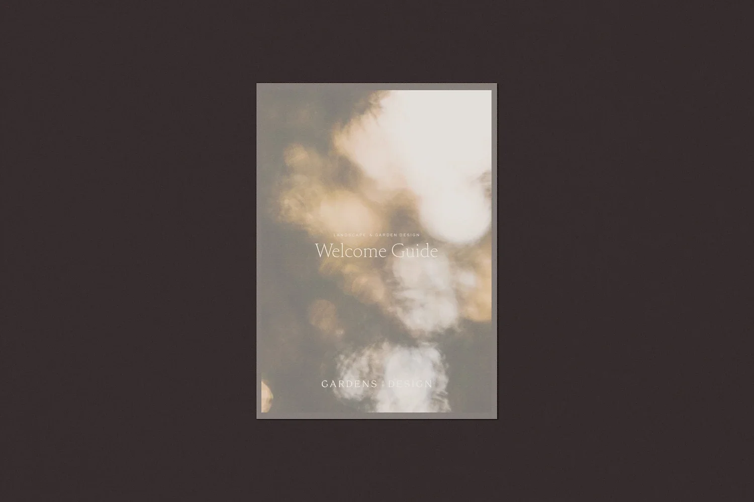 Cover of the Gardens by Design Welcome Guide document featuring elegant typography set against a soft blurred background