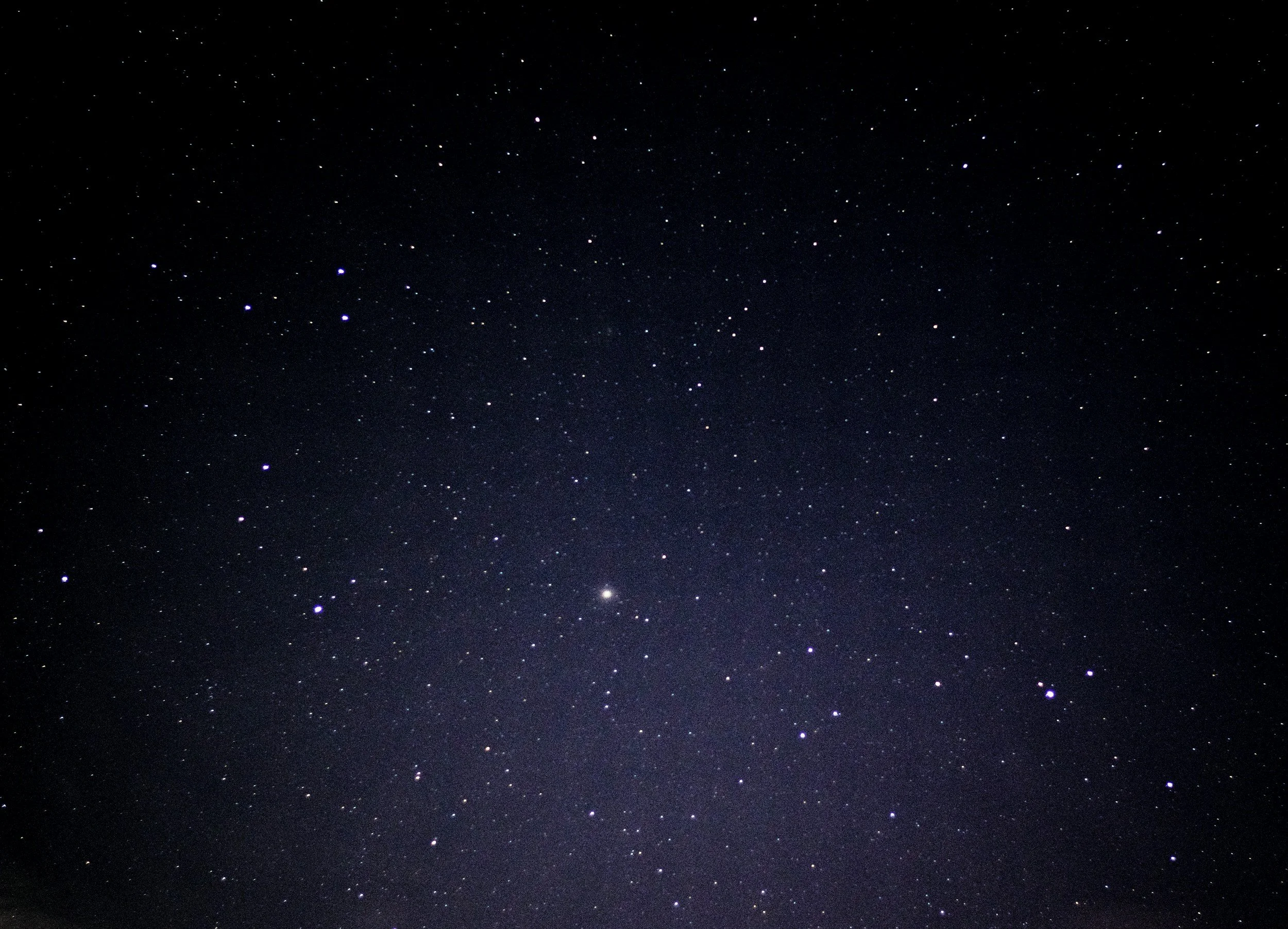 Starry night sky with numerous visible stars against a dark background.