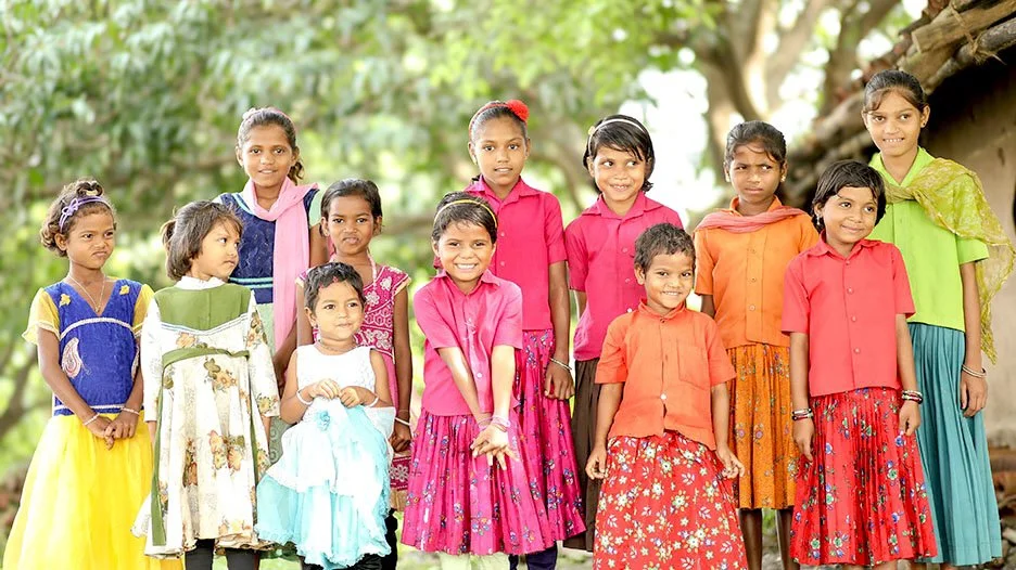 Group of girls in bright dresses outside