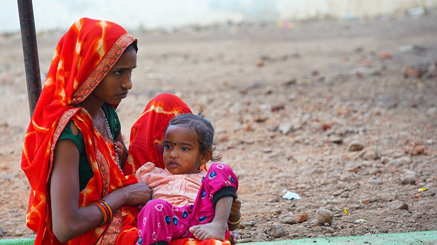a young woman holds a toddler in South Asia  | Daughters of Azaadi