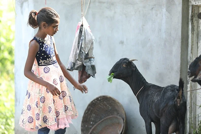 young girl with goat