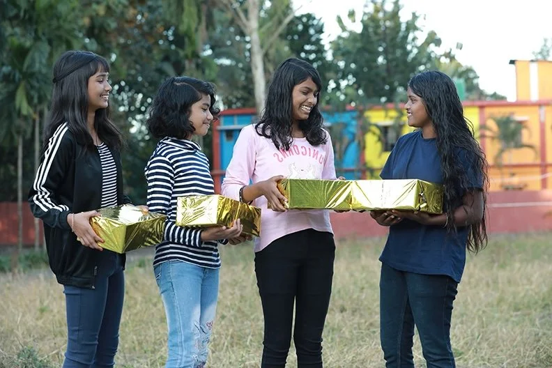 girls holding gift boxes
