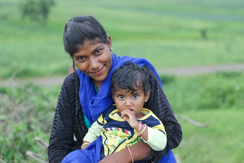 a woman holds a small child