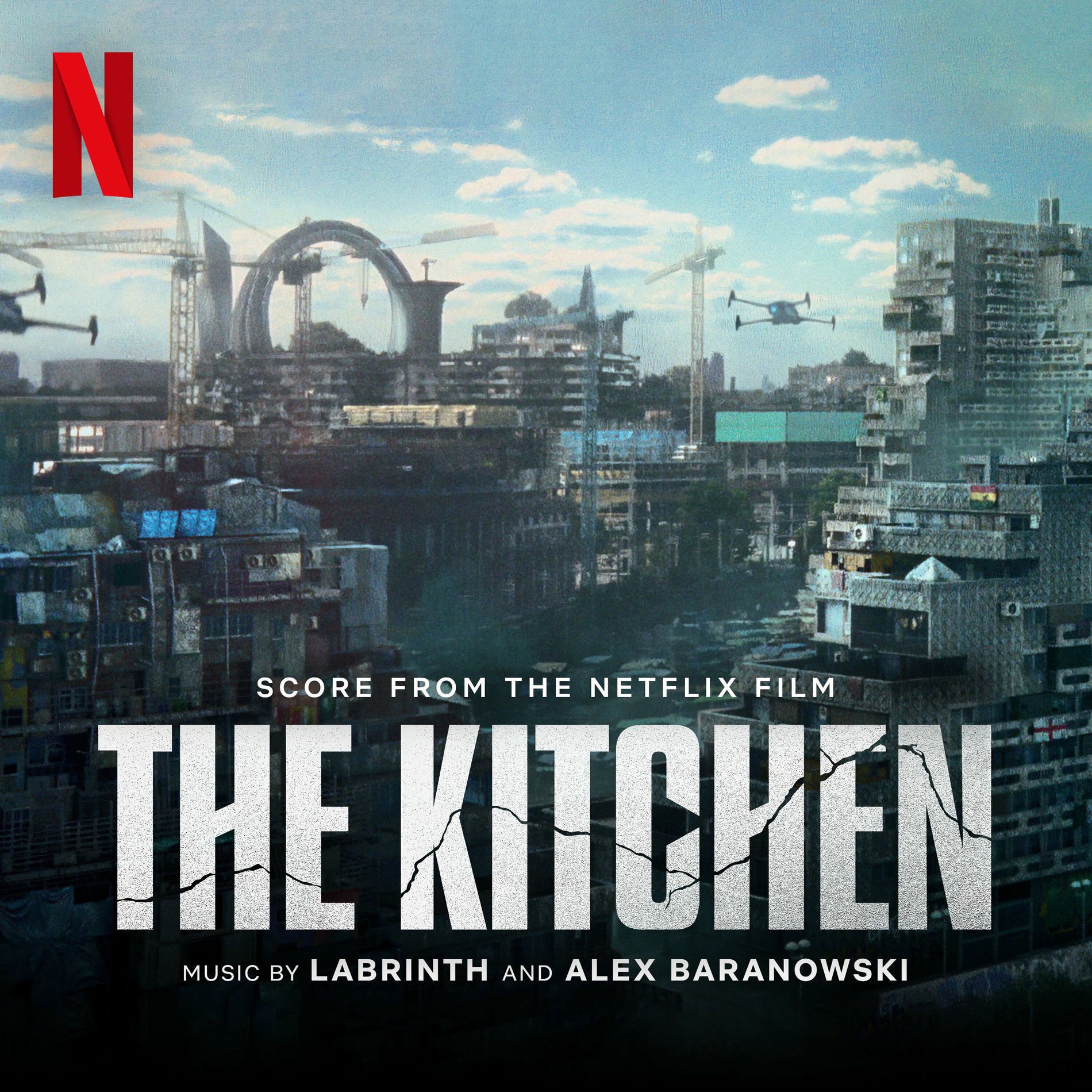 Movie poster. A dystopian cityscape with tall, dark buildings and construction cranes, flying drones, a cloudy sky, and bold white text promoting the Netflix film 'The Kitchen' with music by Labrinth and Alex Baranowski.