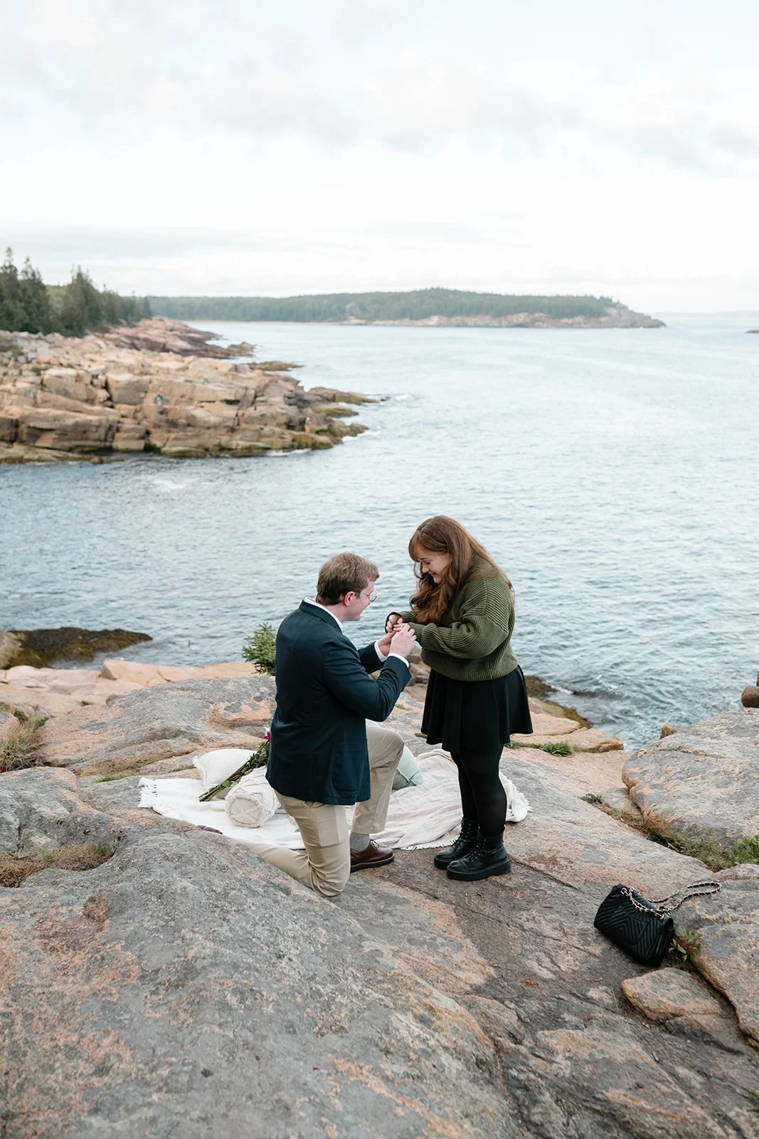 maine surprise proposal along the coast overlooking ocean