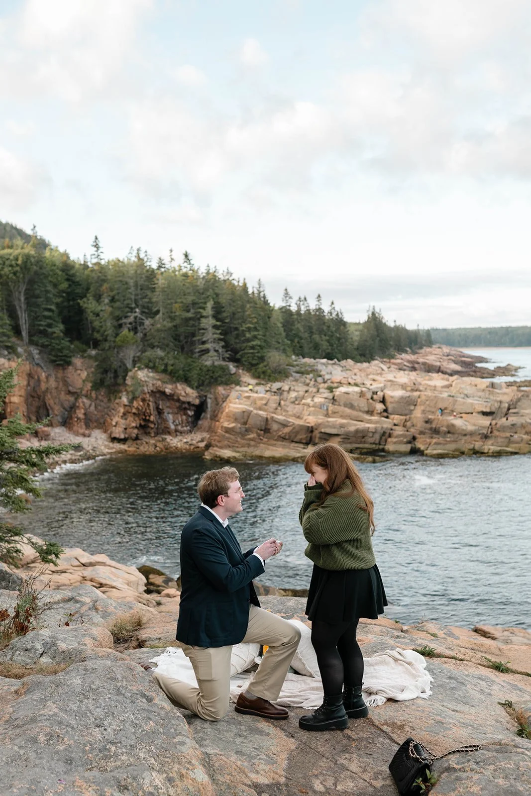 maine surprise proposal along the coast overlooking ocean