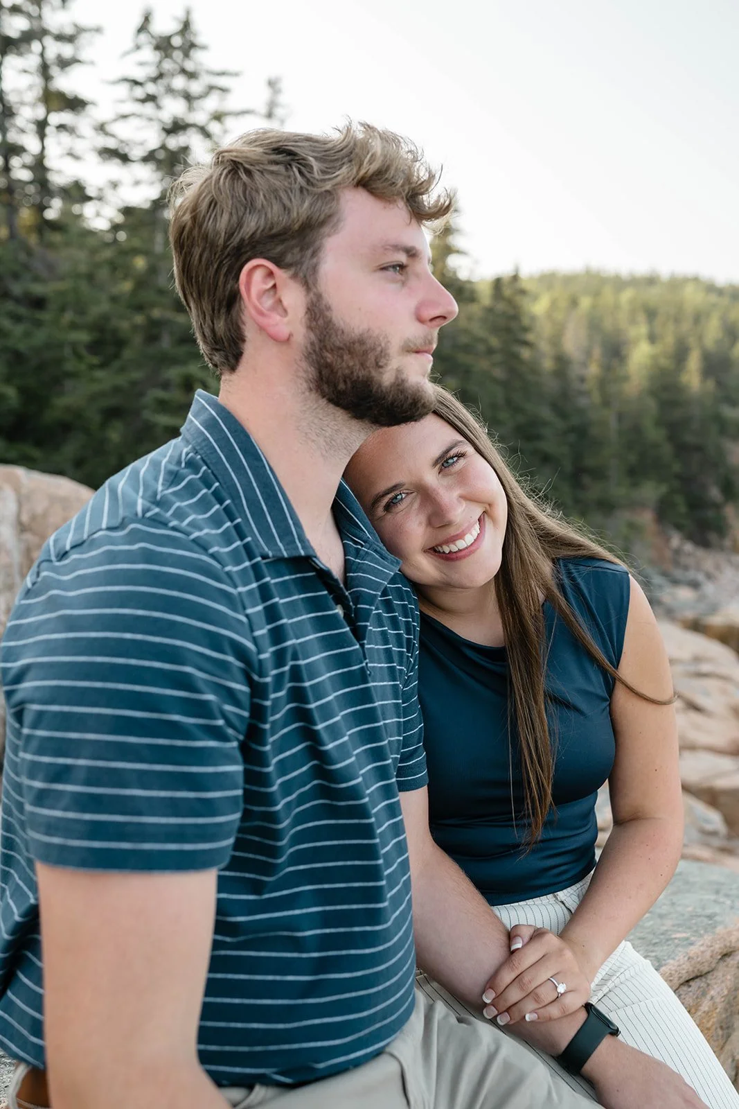 newly engaged couple enjoying the moment along the maine coast