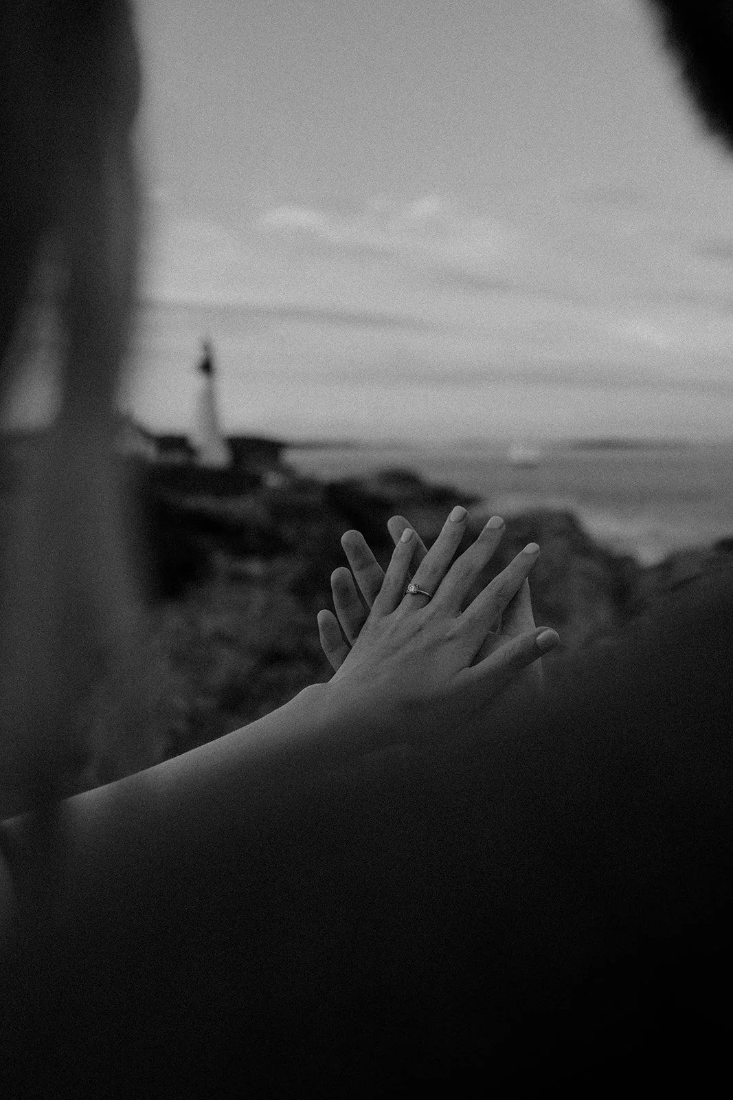 surprise proposal overlooking a lighthouse in maine