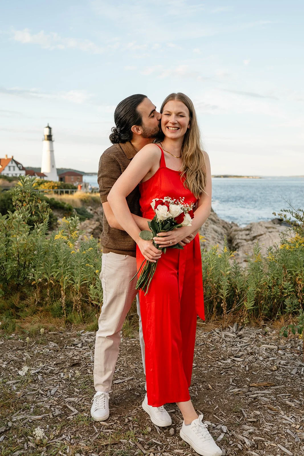 surprise proposal overlooking a lighthouse in maine
