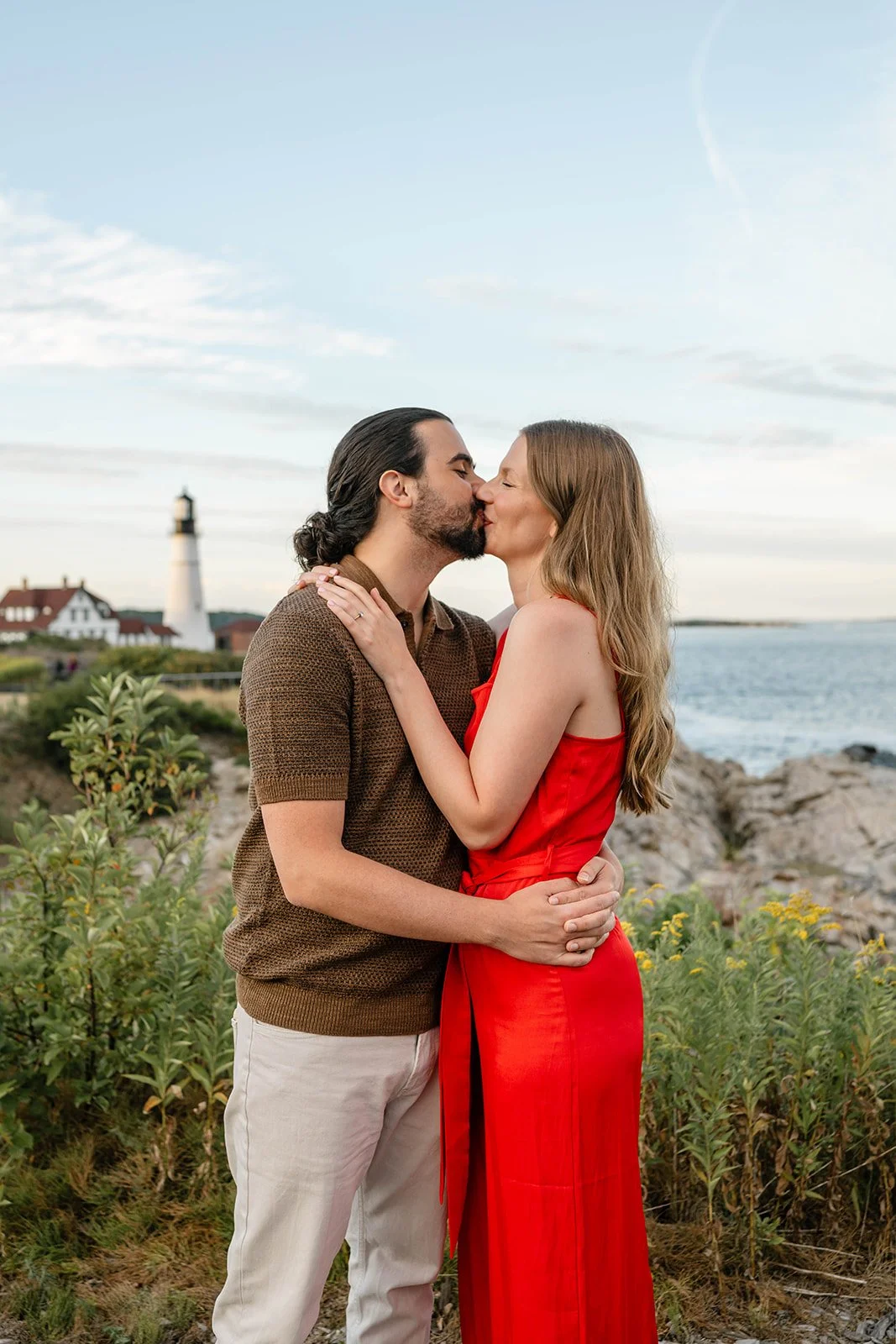 surprise proposal overlooking a lighthouse in maine