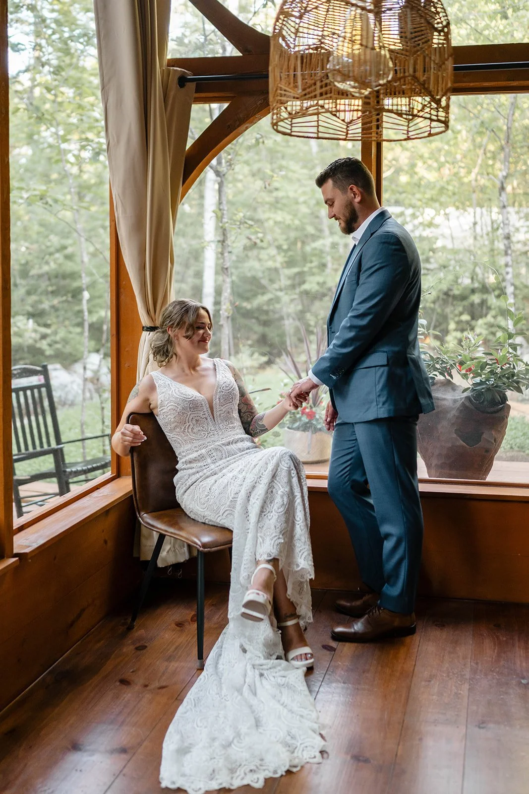 couple getting ready together during a lakeside cabin elopement in Maine