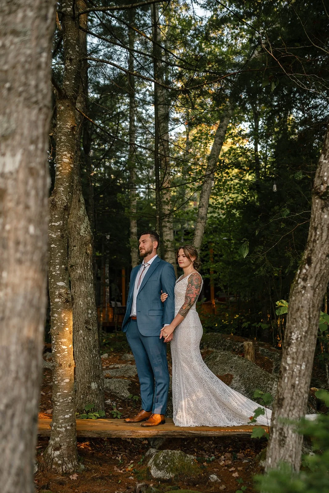 bride and groom surrounded by lush forest in maine