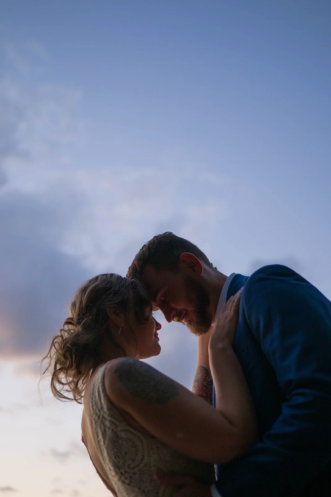 elopement couple during blue hour on the dock for their lakeside cabin elopement in Maine