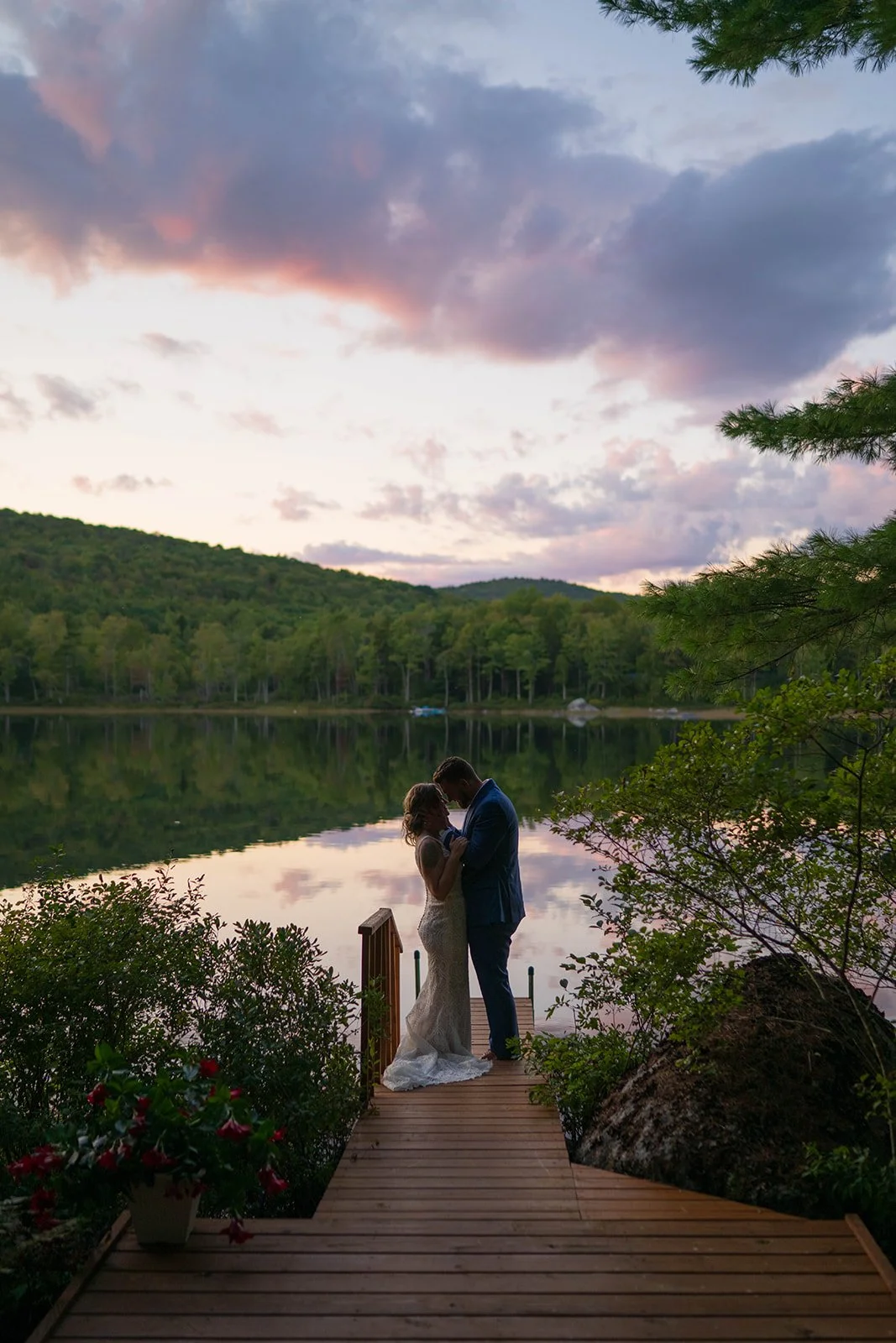 elopement couple during blue hour on the dock for their lakeside cabin elopement in Maine