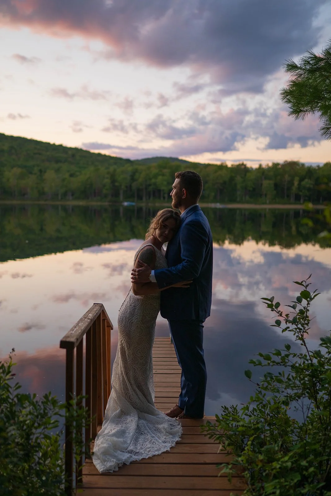 elopement couple during blue hour on the dock for their lakeside cabin elopement in Maine