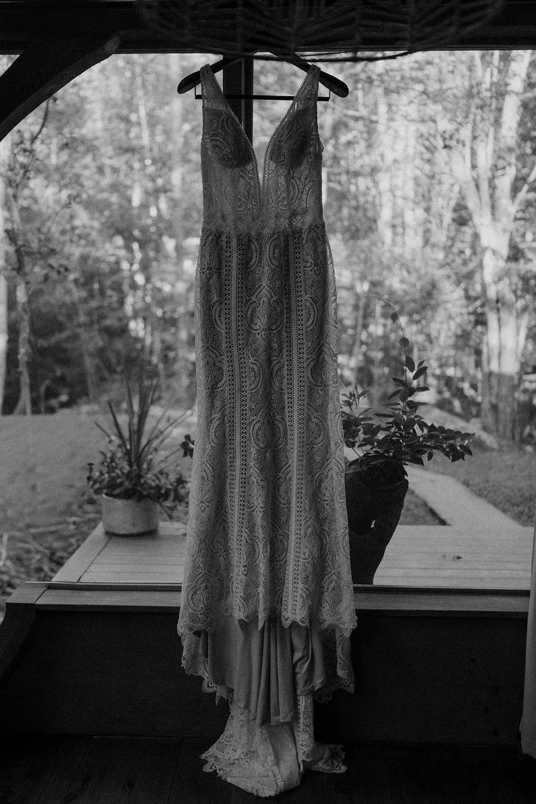 wedding dress hanging from a window
